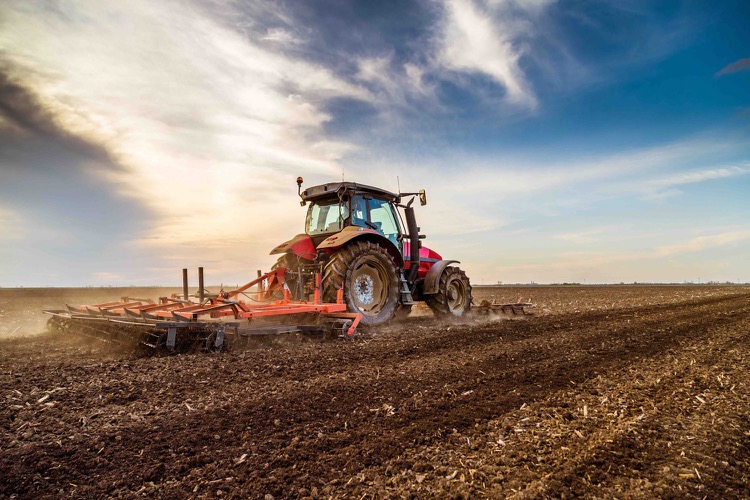 A tractor plowing a field.