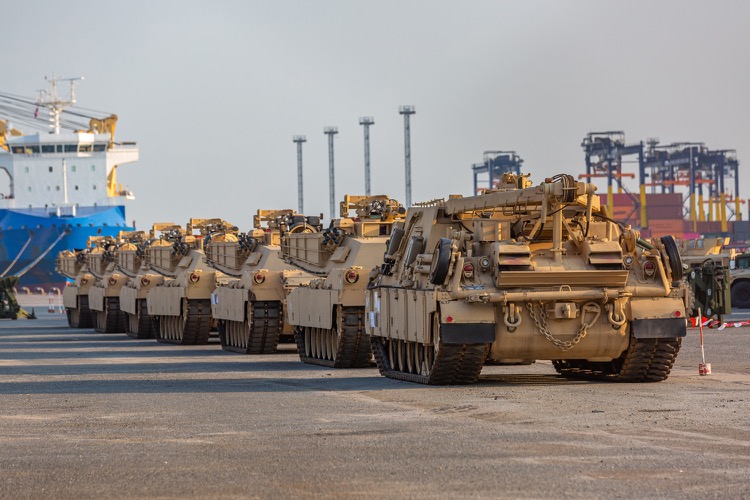 A line of heavy vehicles with tank treads
